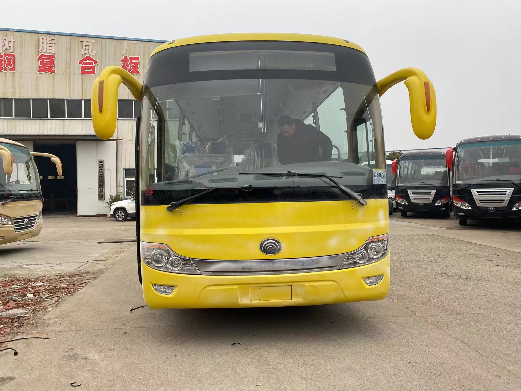 Tourist Luxury Bus with Toilet Suspension Leaf Spring and 70 Seater Capacity