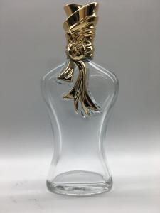 Quality Embossed Logo Empty Perfume Glass Bottles Body Shape Unique Cap 100ml for sale