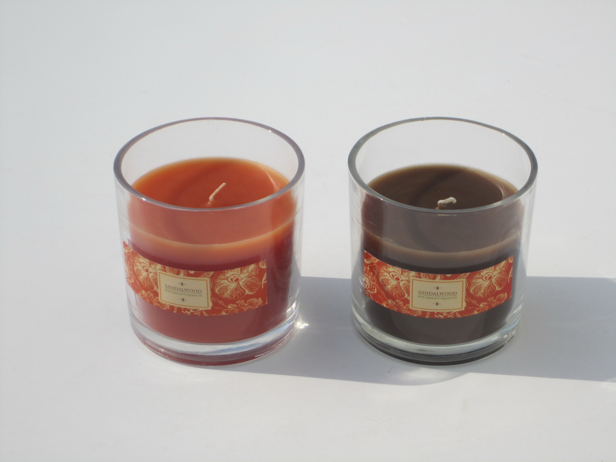 Orange & brown scented glass jar candle with printed label packed into gift box